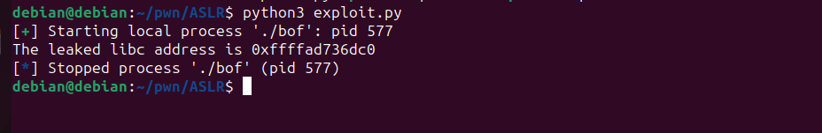 Python exploit script output showing the leaked libc address
